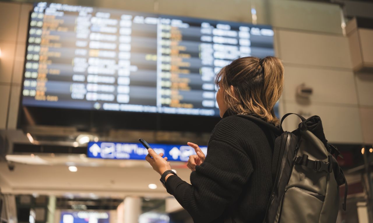 Airport departure board showing delayed and canceled flights in the United States